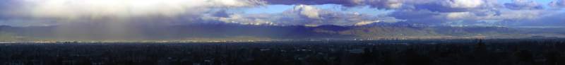 Panorama: A winter storm over San Jose, CA, with snow on mountains
