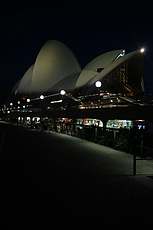 Opera House at night on walkway from Circular Quay

