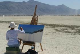 Woman paints the desert out at the edges of the city
