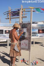 ATM customer examines his playa money.