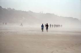 At the beach was a high school track meet.  Here the kids run down the beach into the mist.
