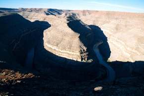 The main gooseneck in Goosenecks State Park, Utah.  See also my panorama.  Normally a river can't meander like this, but when the plateau is being lifted up at the same time the river is carving, you can get this pattern.
