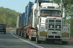 A Road Train, which has up to three trailers towed by one truck.  It's how a lot of stuff moves in the outback.  They don't go into the cities
