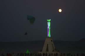 Not a great shot, but it shows parasailer, the Man and the full Moon, and the lit emerald City int he background.
