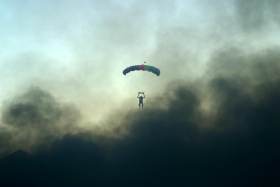 Skydiver lands in cloud of black smoke on he Playa