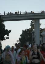 Spectators crowd the overpass at dusk