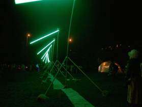 The alien semaphore at night with flying, glowing green fluorescent tubes