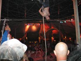 A circus act in the center camp cafe at night