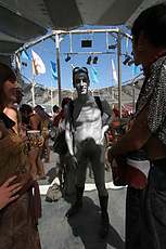 Silver man in center camp