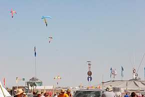 Skydivers come in for landings above center camp