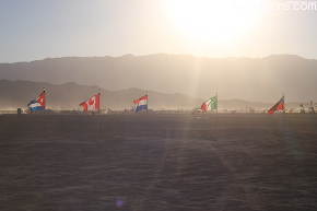 Part of a line of flags in the playa near the man