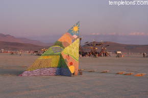 Mutopia hides behind another art piece at sunrise.