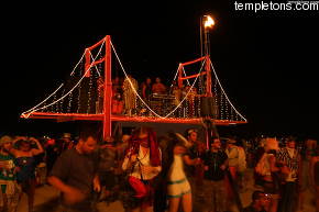 A Bus turned into the golden gate bridge observes fire dancers