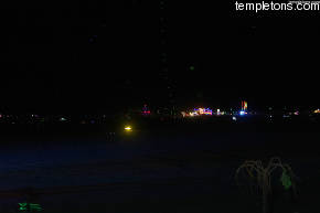 Out in the deep playa, a line of balloons holding LEDs rises into the sky.  Also Babel and Purple Palace