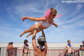 A couple performs gymnastic moves on top of Babel
