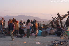 People gather at sunrise at the remains of the man