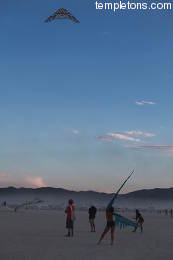 Fly kites at dusk