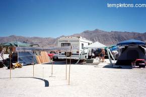 Our camp, early in the morning.   My 15 foot long picture of the 1998 Black Rock City is on display on a curved board I built for it.