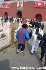 A footbound woman on her way into the Forbidden City.  Foot binding is no longer practiced, so only the old suffer from it.
