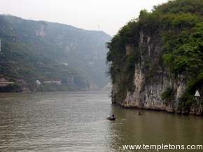 Old boat travels past walls in Xiling