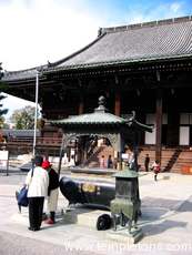 Chion-in temple.  The old lady has put some incense in the brazier.