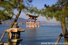 The Torii is framed by trees.  Western Hiroshima in the background