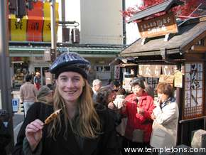 The Japanese don't eat while walking, unless it's on a stick. This is just some white paste, grilled and coated in sauce, on a stick.  Terry Pratchet might expect to be offered 