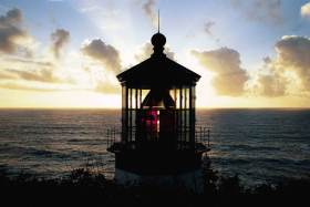 The lighthouse at Cape Meares, with the sunset behind the lens.