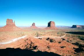 The view from the visitor center at Monument Valley.  The Navaho road leads into the valley.    These are the 