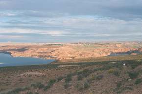 The back of Glen Canyon Dam on the right, and the town of Page, AZ above it.